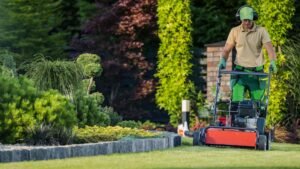 landscaper at work using an aerator on lawn